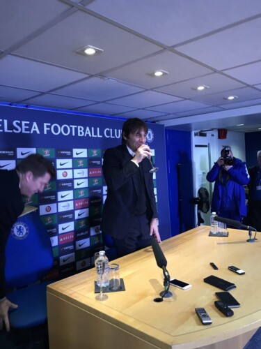 Antonio Conte raises a glass of sparkling wine