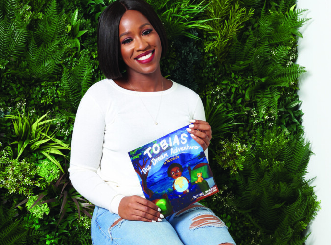 Destynee Onwochei with her book