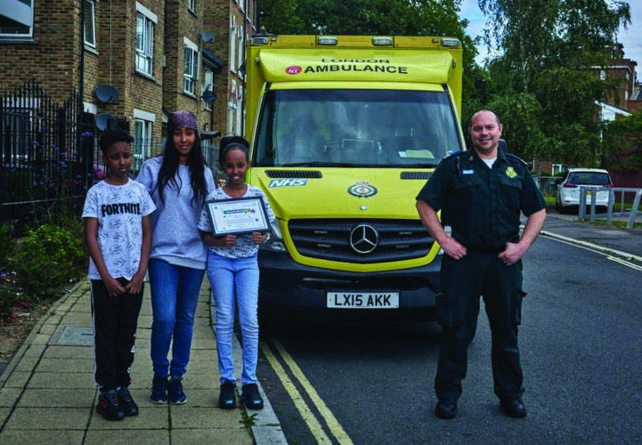 Rawda, twin brother Ridwan, and their mum Anisa with medic Stuart Shelley
