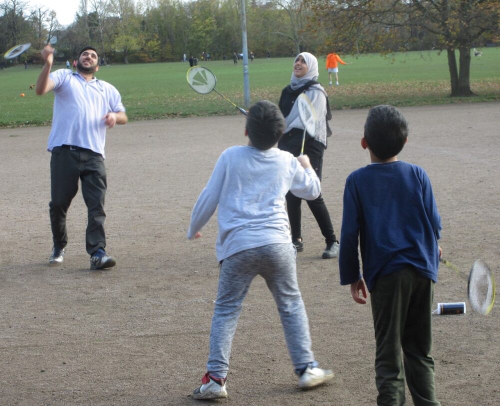 Pictured: Residents play badminton at Tooting Triangle; Mohammad Hiaran and his family are anti the development and said he would write in to object. 